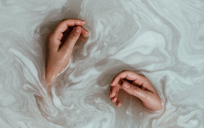 hands in milky water