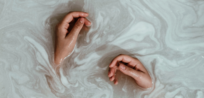 hands in milky water